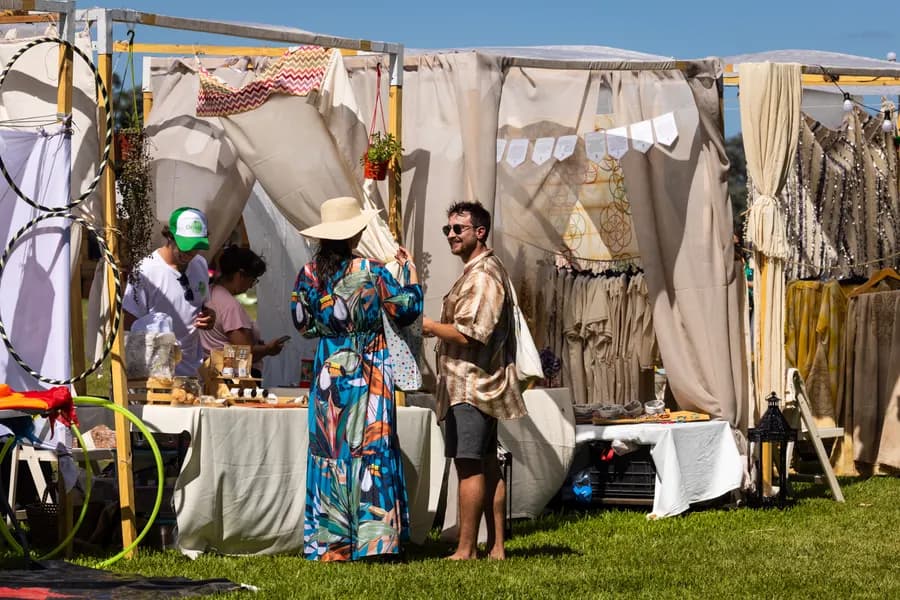 Market stalls with clothing, art and products from makers